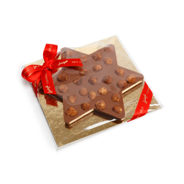 Beste Schweizer Milchschokolade, veredelt mit caramelisierten Piemonteser-Haselnüssen in Zürich online bestellen und liefern lassen